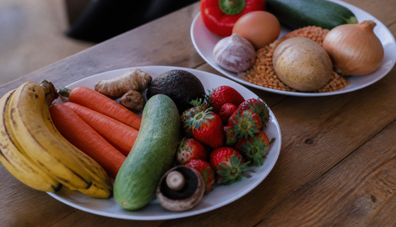 Deux assiettes avec fruits legumes et provisions alimentaires