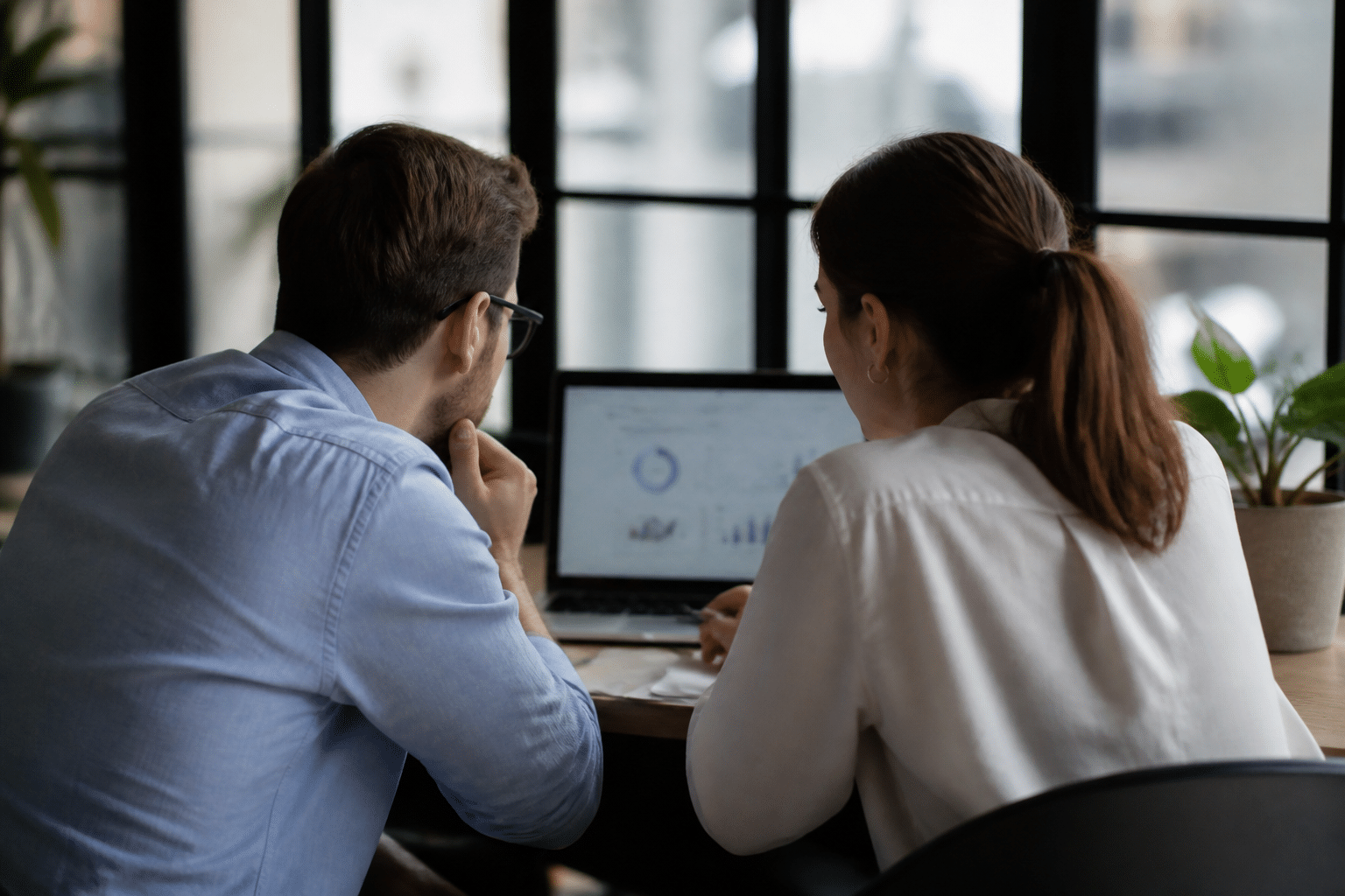 Hommes et femmes consulter statistiques emploi sur écran ordinateur